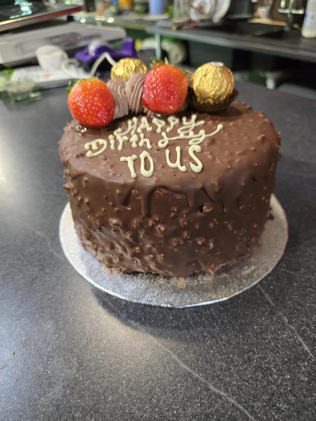 Chocolate cake with a crunchy coating, strawberries and gold chocolates